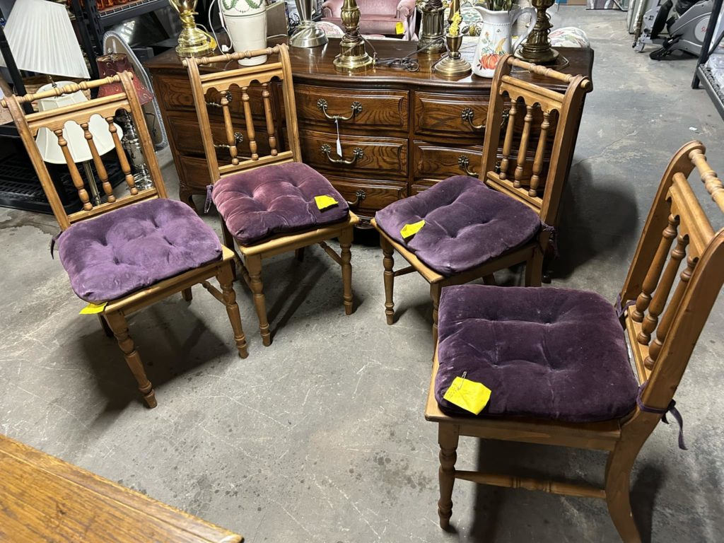 Four matching chairs with purple cushions